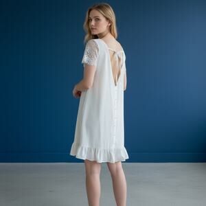 extra small white shift mini dress short sleeves ruffled hem open back detail